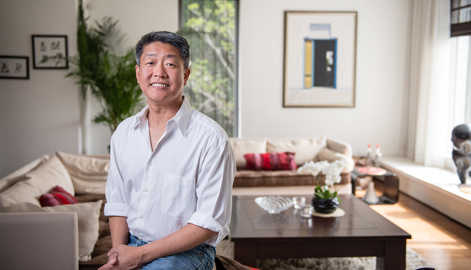 Esmond Quek sits in his living room in Beijing.