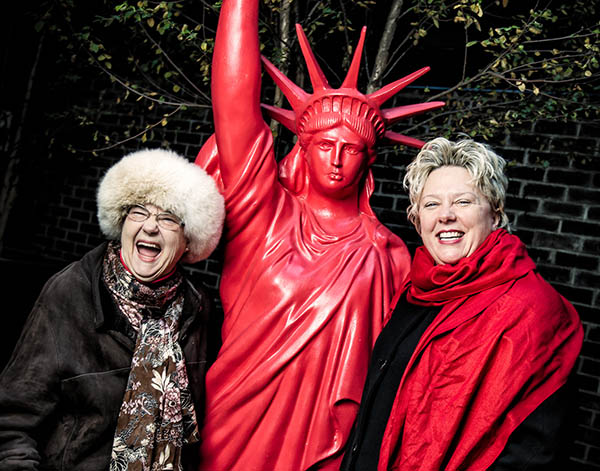 Val Grubb poses with her mom Dorothy and a replica of the Statue of Liberty painted red.